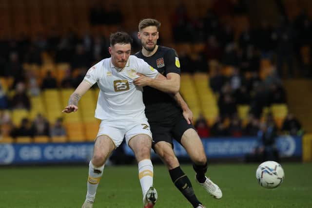 Jon Guthrie battles with former Cobblers loanee Ryan Edmondson. Picture: Pete Norton.