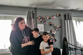 Rhianne in her damp bedroom with her two children (11 and seven)