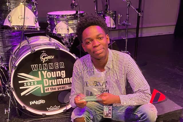 Jeramie Animan with his award and new drum kit.