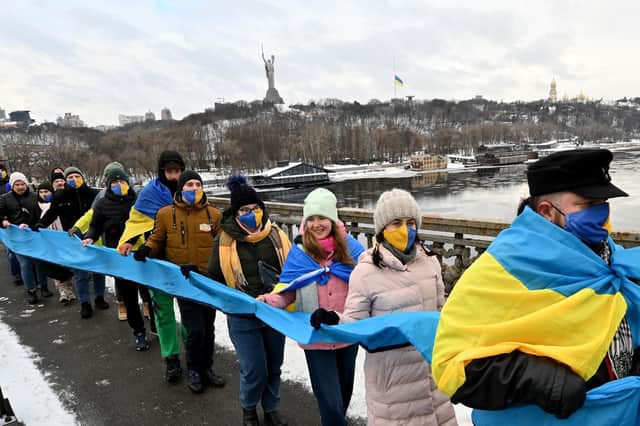 People form a symbolic human chain on a bridge across the River Dnieper in Kiev, to mark the Day of Unity of Ukraine, on January 22