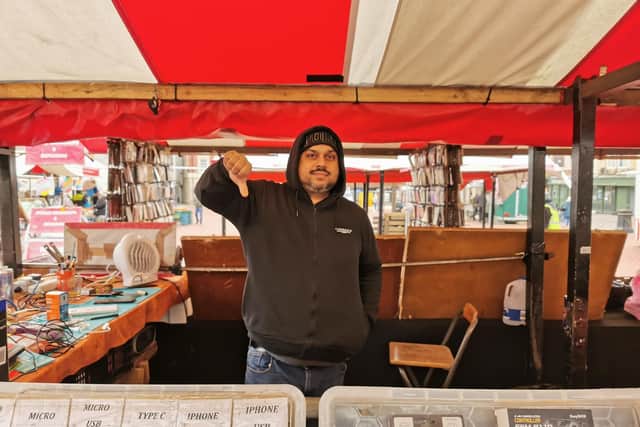 Lug Singh, who has been running a mobile phone stall for 18 years on the market, disagrees with the decision. Photo: Logan MacLeod