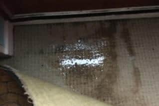 Water pours through the resident's front door every time it rains.