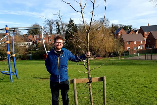 George Turner, 29, with his oak tree that he grew from an acorn when he was presented with it as part of the millennium celebrations in 2000.
