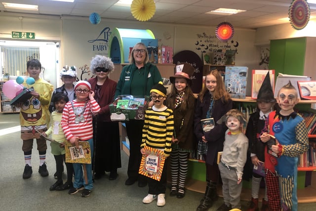 Alison Whitburn, community champion at Morrisons Littlehampton, at St Catherine's School to donate a bundle of books for the school library