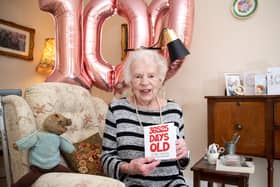 Jill Wood, 100, holding her favourite birthday card. Photo by Kirsty Edmonds.