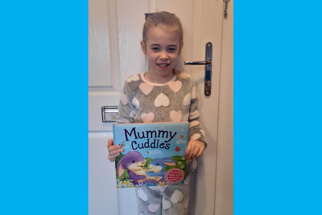 Caldecote CE Academy children wore pajamas and took their favourite book - Madison is pictured with her favourite Mummy Cuddles