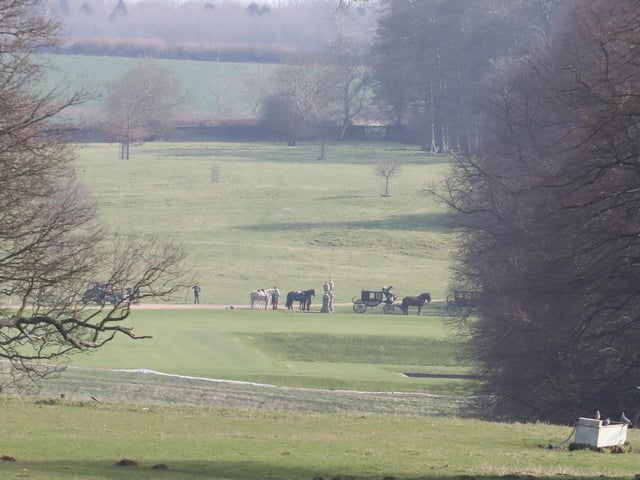 Horses and carriages wait to get on the set