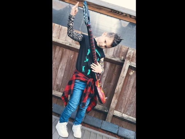 Jacob, aged nine, has fully embraced the rock n' roll theme set by his school - rock on, Jacob!