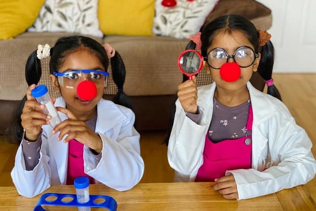 Hesali, aged seven, and Senuli, aged six, dressed for their school's science theme.