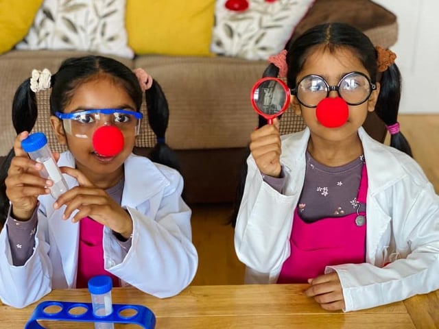 Hesali, aged seven, and Senuli, aged six, dressed for their school's science theme.