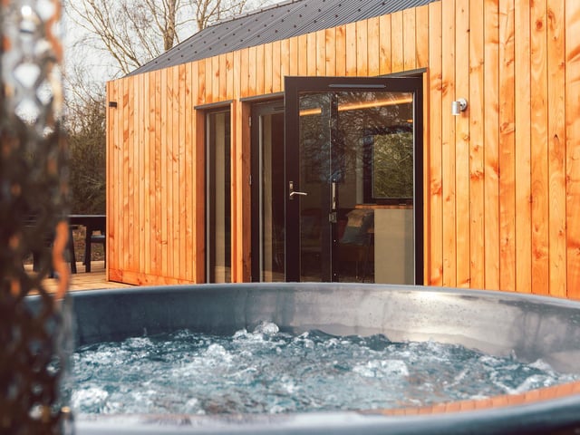 Soak up your surroundings with the star of the show: the outside hot tub.