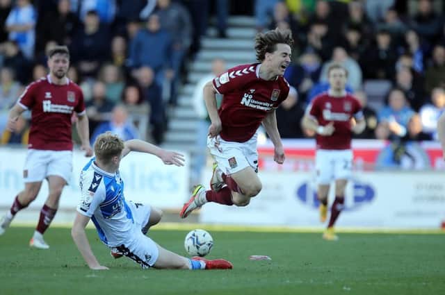 Louis Appere feels the force of this Connor Taylor challenge during the Cobblers 1-0 defeat to Bristol Rovers on Saturday (Pictures: Pete Norton)