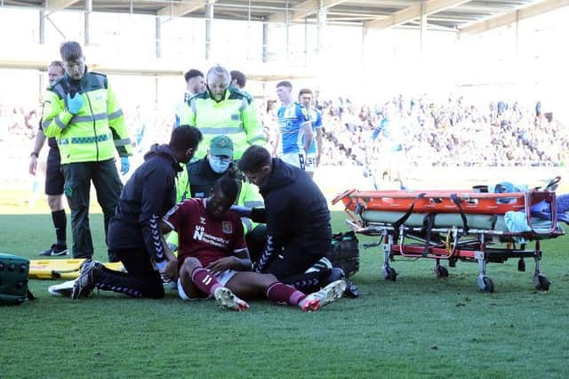 Tyler Magloire is attended to after dislocating his shoulder in Saturday's 1-0 defeat to Bristol Rovers (Picture: Pete Norton)