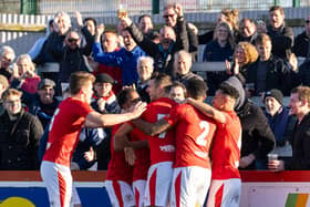 Lee Ndlovu is mobbed by his Brackley Town team-mates after he scored the only goal of the game against Kidderminster Harriers. Picture by Glenn Alcock