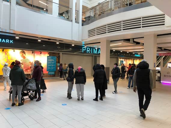 Shoppers queue outside Primark in Northampton Grosvenor Centre for 8am opening