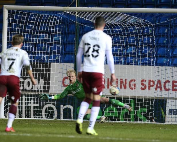 Jonathan Mitchell can only watch on as Jonson Clarke-Harris slots his penalty down the middle. Pictures: Pete Norton.