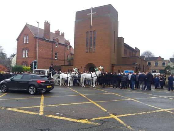 Mourners outside the church at the funeral.