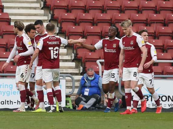The Cobblers players celebrate Peter Kioso's second goal in the 3-0 win over Ipswich Town on Tuesday night (Pictures: Pete Norton)