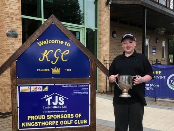 Fourteen-year-old Sam Dunkley celebrating his victory at a men's golf tournament at Kingsthorpe Golf Club.