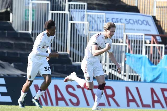 Fraser Horsfall wheels away in delight after bringing Cobblers level. Pictures: Pete Norton