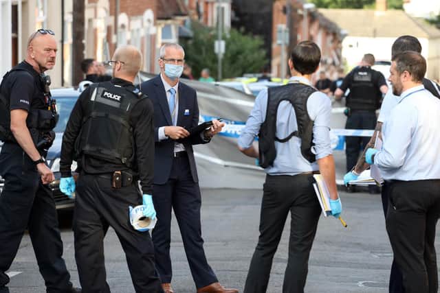 Detectives at the scene in Russell Street.