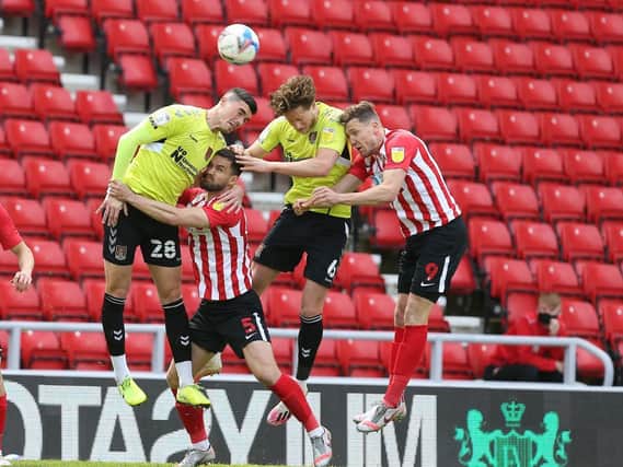 Fraser Horsfall and Lloyd Jones challenge for a header at the Stadium of Light. Pictures: Pete Norton.