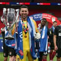 Steve Arnold celebrates the Cobblers' league two play-off final success at Wembley in June. The goalkeeper has now been released by the club