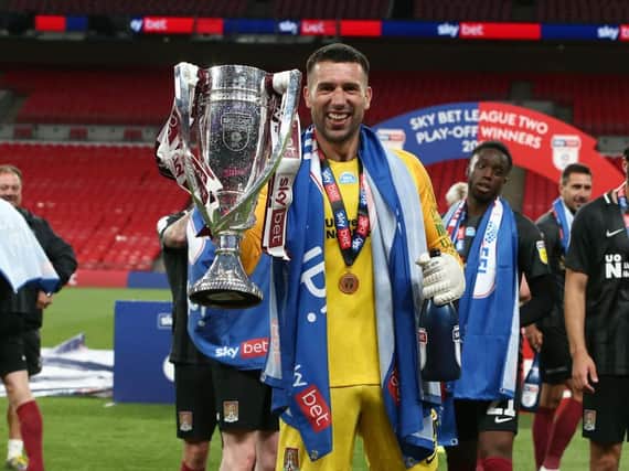 Steve Arnold celebrates the Cobblers' league two play-off final success at Wembley in June. The goalkeeper has now been released by the club
