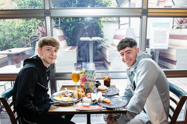 Logan Grieve (right) and Samuel Moon (left) tucking into their breakfast. Photo: Kirsty Edmonds.