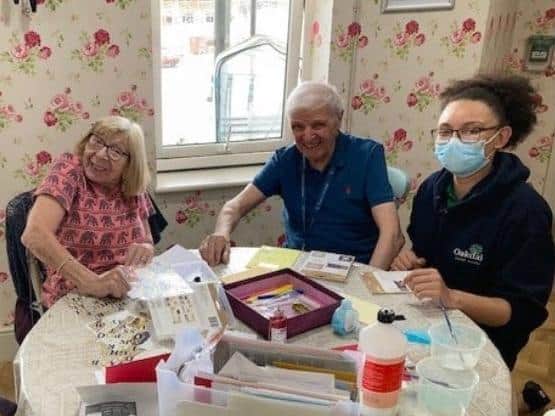 Timken Grange residents and a member of staff make cards to thank nurses.