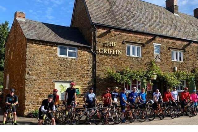 Cyclists who took part in last year's fund-raising ride are pictured outside The Griffin pub in Chipping Warden, which hosts the start and end of the event
