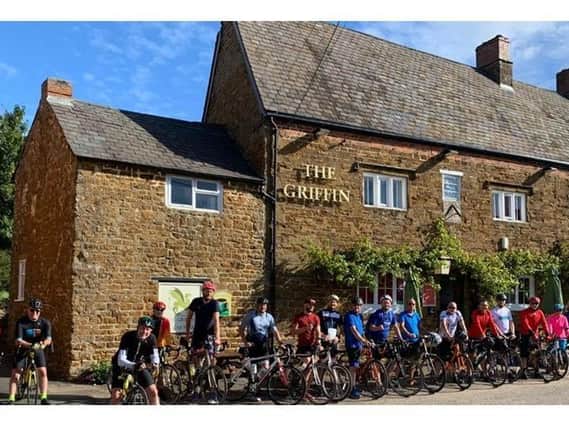 Cyclists who took part in last year's fund-raising ride are pictured outside The Griffin pub in Chipping Warden, which hosts the start and end of the event