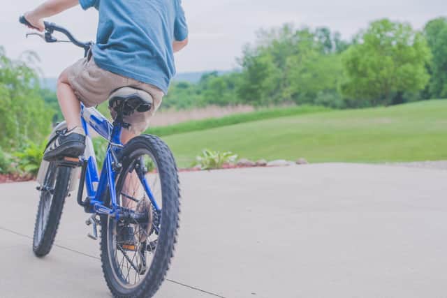 A teenage girl was pushed off her bike, causing her to break a finger.