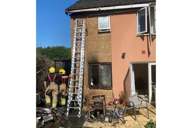 Firefighters at a house in Northampton damaged by a fire caused by burned waste that was not completely extinguished. Photo: Northamptonshire Fire and Rescue Service