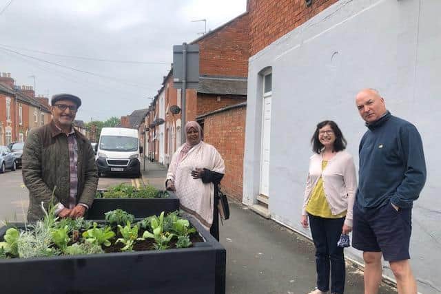 West Northamptonshire councillor Jawal Alwahabi (far left), Northampton Town councillor Fartun Ismail (centre) and two of the neighbours with the new planters on Queens Road, Northampton