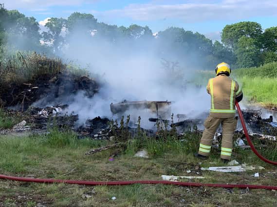 Firefighters had to hose down a pile of burning waste two times in one evening.