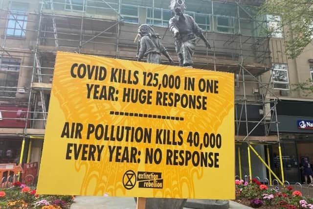 Extinction Rebellion put up posters around the iconic statue in Abington Street