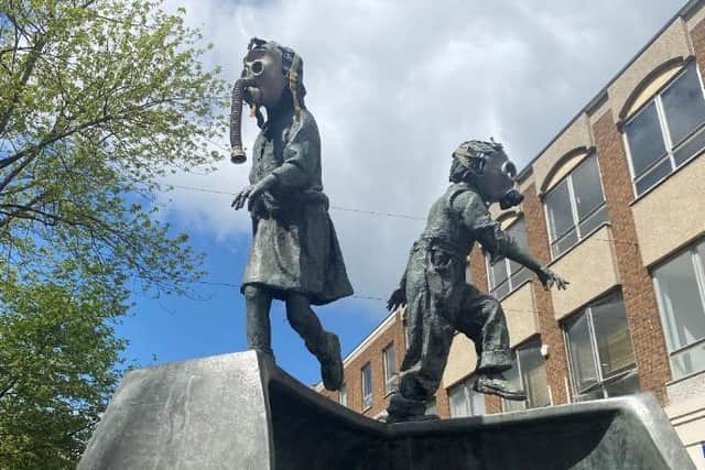 XR put gas masks on the children running on a shoe statue in Abington Street to highlight the issue of air pollution in the town