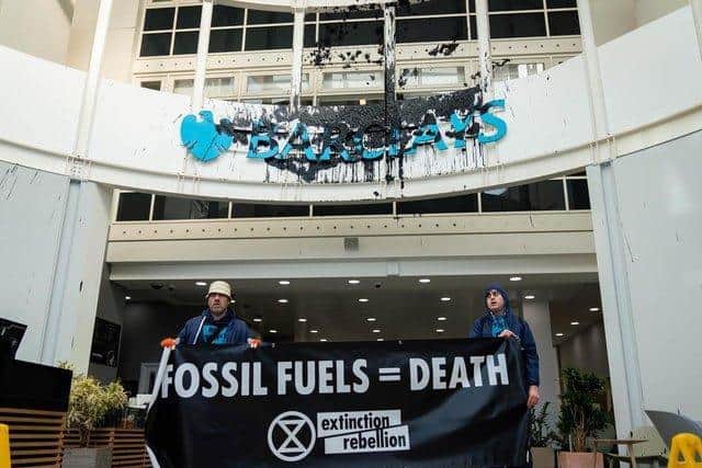 This is the scene from the protest on February 26 last year, which shows the Barclays logo was sprayed black and banners were unveiled.