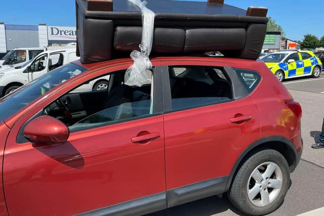 Police found the sofa tied with plastic to the top of a car