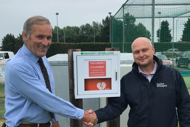 Towcester Sports and Social Club chairman Frank Osbourne (left) and Taylor Wimpey South Midlands production director Kevin Salisbury with the new defibrillator