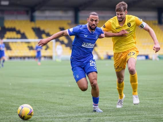 Jon Guthrie battles with Rangers player Kemar Roofe whilst playing for Livingston.