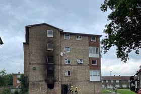 The block of flats shows smoke damage on the outside