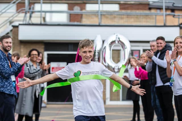 Reiss Wheatley-Crane crosses the finish line at Northampton General Hospital after running 100km in June for the children's wards' appeal for a new outdoor play area