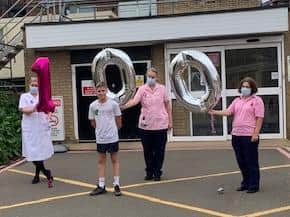 Northampton General Hospital staff with Reiss Wheatley-Crane after crossing the finish line on his 100km running challenge