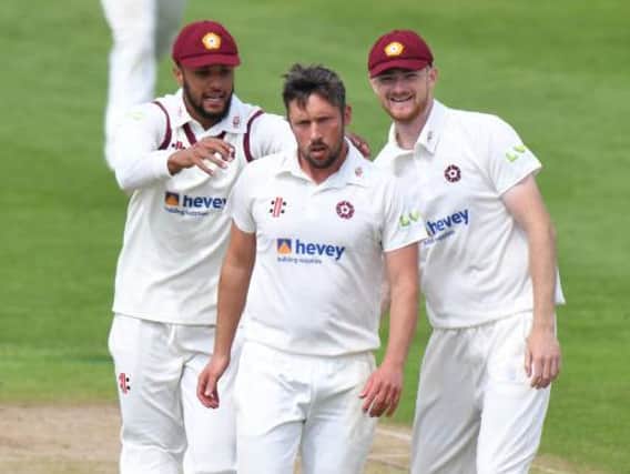 Simon Kerrigan is congratulated by Emilio Gay (left) and Tom Taylor after claiming one of his four wickets against Yorkshire