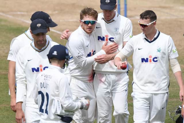 Dom Bess (fourth from left) is congratulated after completing his seven-wicket haul against Northants