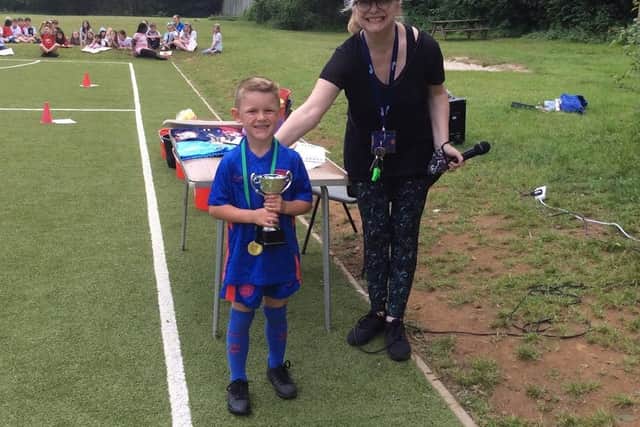 Broughton Primary School penalty shoot-out winner Preston Radford Philiips, six, with head teacher Mary James