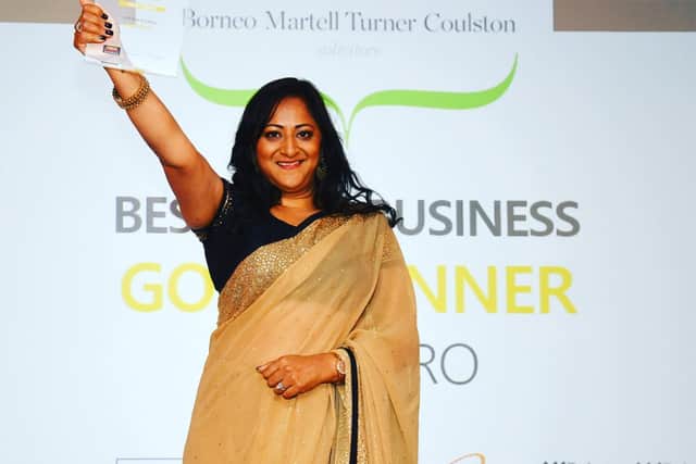 Gita collecting the business' awards.