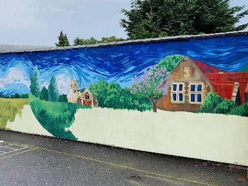 The mural includes a painting of the school.